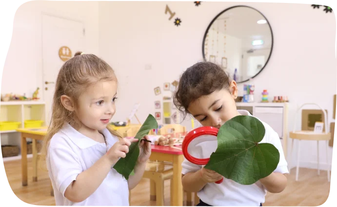 Foundation-aged children engaged in open-ended play with natural materials at Step by Step Nursery Dubai, fostering creativity and curiosity.