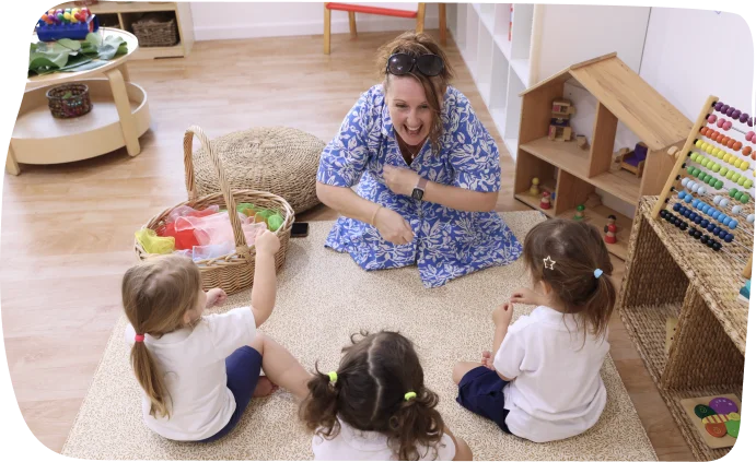 Toddlers engaged in a circle time action song activity at Step by Step Nursery Dubai, encouraging social interaction and fun.