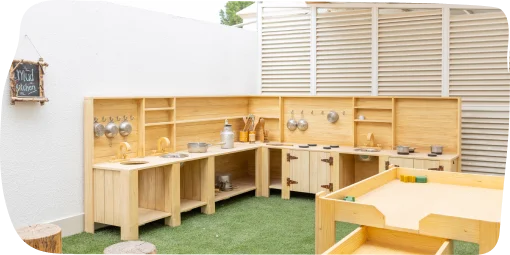 Outdoor learning environment at Step By Step Nursery in Umm Suqeim, featuring a well-structured mud kitchen for hands-on play and collaboration.